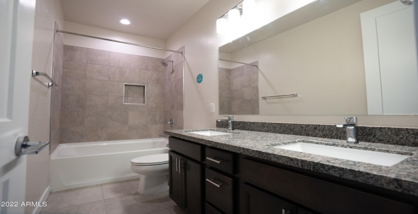 Granite counters, double sinks, shower/tub combo.