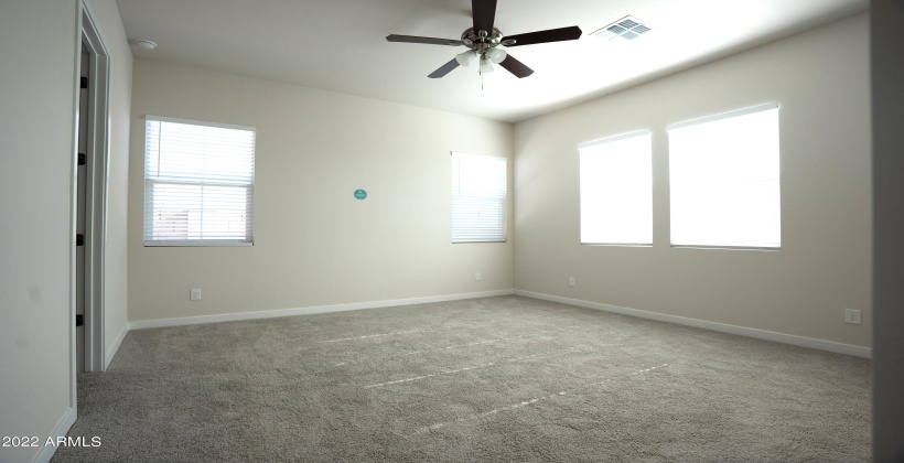 Spacious high ceiling master bedroom.