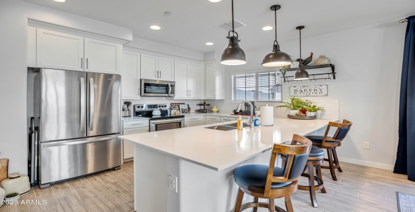 Beautiful appointed kitchen with stainless steel appliances and quartz countertop