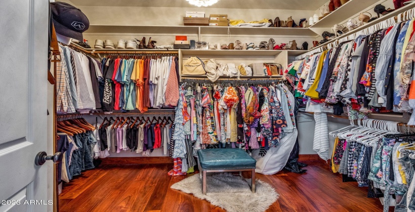 Primary closet with lots of space & hardwood floors.