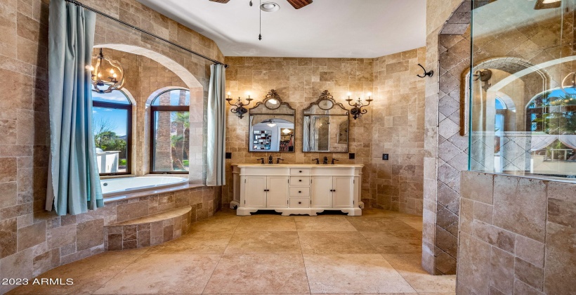 Primary bath with gorgeous old world stone and lots of room to add more cabinets.