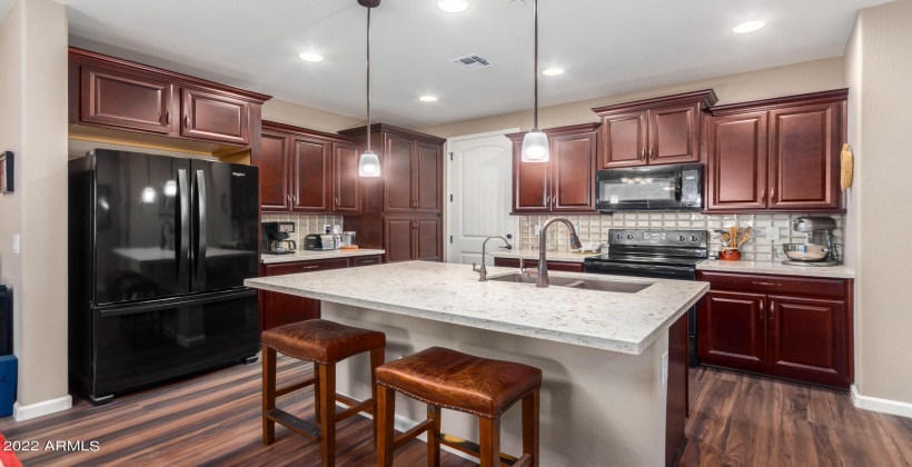 Gourmet Kitchen with staggered cabinetry and open island with breakfast bar!