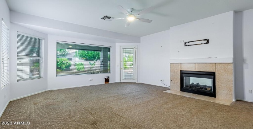 Two Way Fireplace, Exit to Back Patio and Pool. Seller is giving $3500 towards carpet replacement