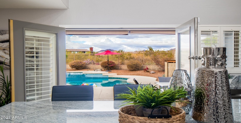 DOUBLE FRENCH DOORS FROM KITCHEN OPEN UP TO THE PATIO AND POOL AREA!