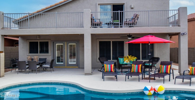 FAMILY SIZE OUTDOOR DINING TABLE UNDER COVERED PATIO AND PLENTY OF LOUNGING AREA FOR ENTERTAINING OUTDOORS!