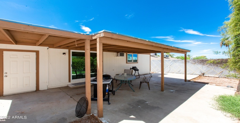 Unit #1 Covered patio, private fenced backyard and laundry room.