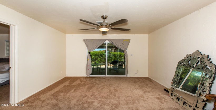 Unit #1 Family Room or other looking out sliding glass doors to covered patio and fenced yard.