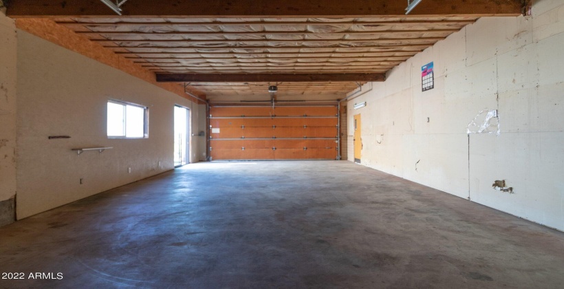 East side of garage has sliding glass door, window and entry door. Another Airbnb possibility? Sewer & water plumbed to structure.