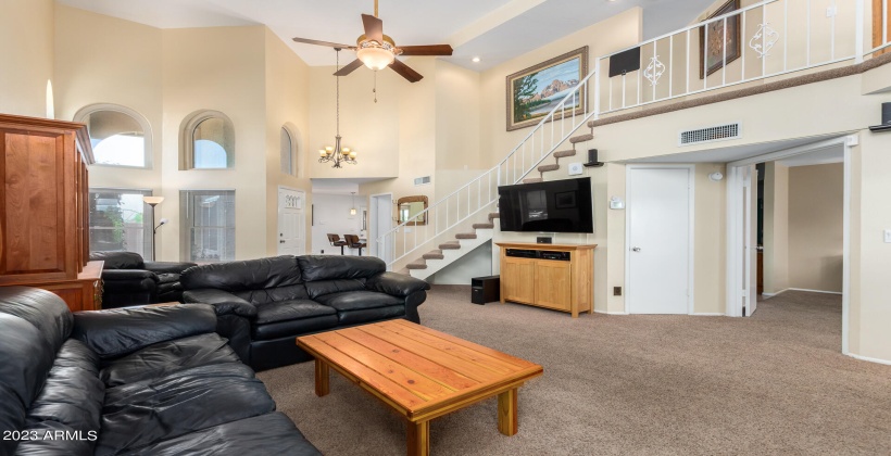 View from Great Room towards front door, Powder Room and Kitchen, note storage closet under stairs.