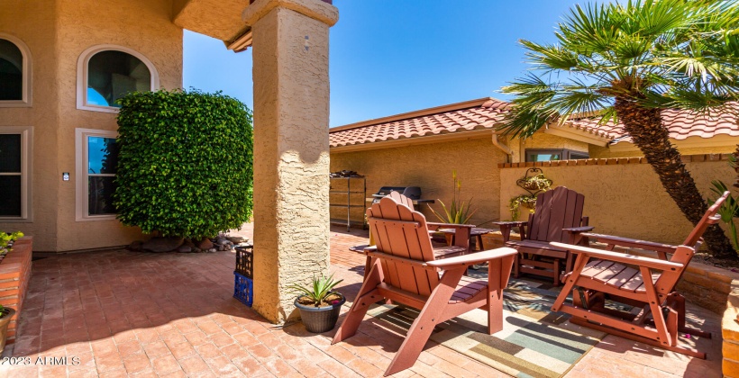 Enter through front gate to relaxing courtyard. Paved walkway to backyard.