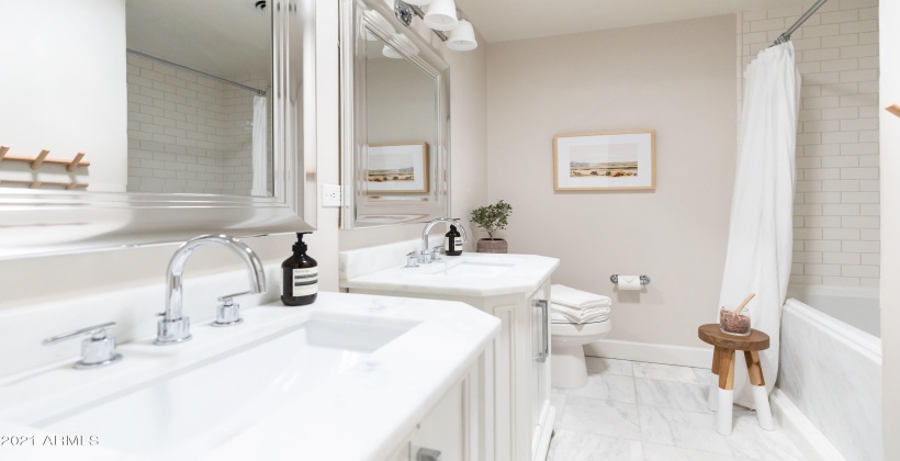 Secondary bathroom with shower and soaking tub.