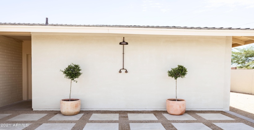 Back patio with outdoor shower and lounge area.