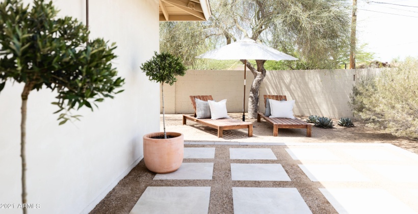 Back patio lounge area and outdoor shower.