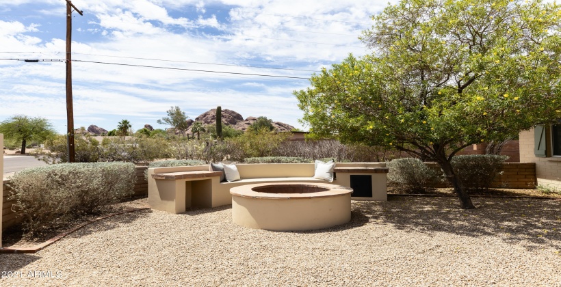 Fire-pit seating area with mountain views.