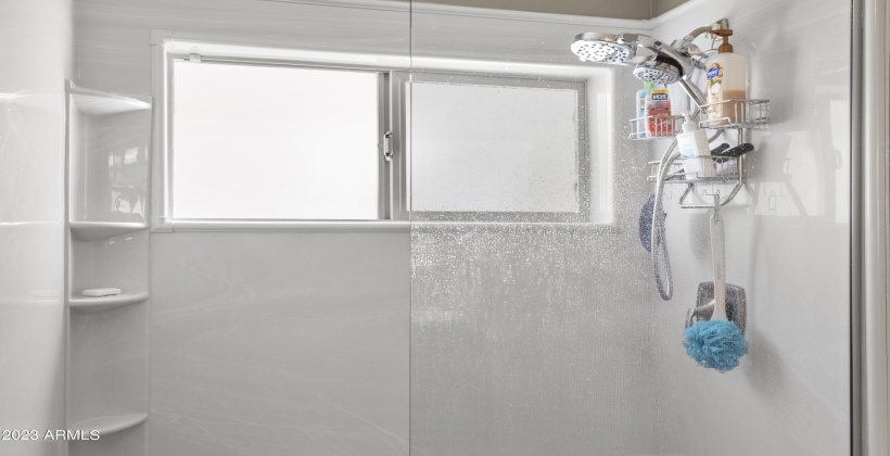 Spacious shower with shelves