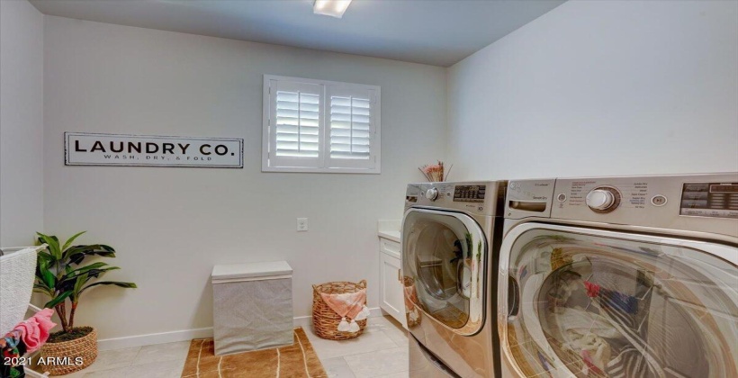 Oversized laundry with stainless steel washer and dryer