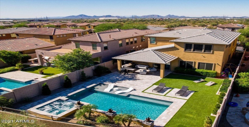 Swimming pool with water fountains and elevated spa