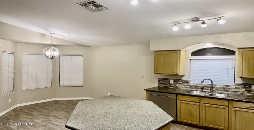 Dining Room and Kitchen Island - Home Features Contemporary Faux Wood Plank Tile Throughout.