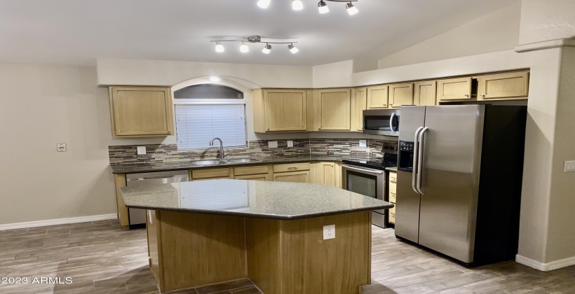 Kitchen Island - Kitchen features granite countertops, tile backsplash, stainless appliances, and beautiful LED lighting.