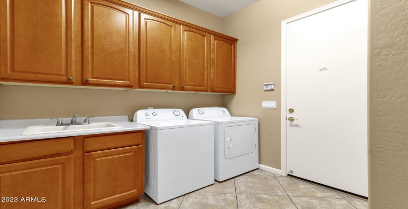 Laundry room with cabinets and utility sink