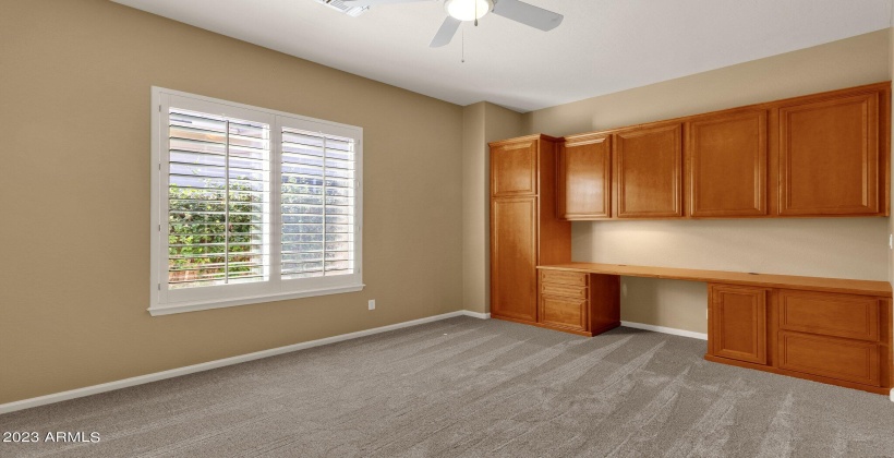 Main level bedroom with office set up