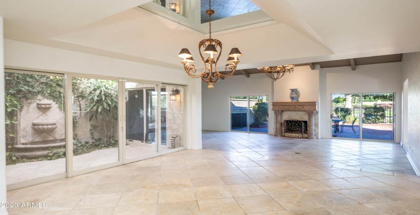 Stunning mirrored tray dining room ceiling with patina-finish bronze and alabaster chandelier.