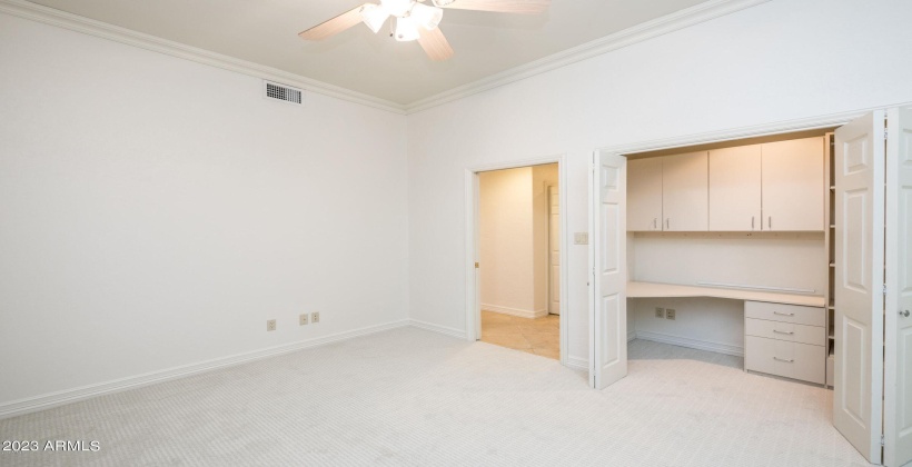 Bedroom #2 has a large closet and half of the closet is a custom workstation office.