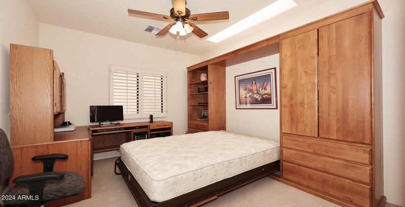 Murphy Bed pulled down with space surrounding the bed.