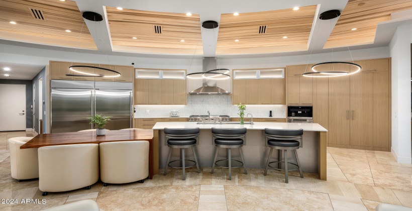 Fully Equipped Modern Kitchen featuring Stainless-Steel Appliances, Breakfast Bar Island and Informal Dining Area.