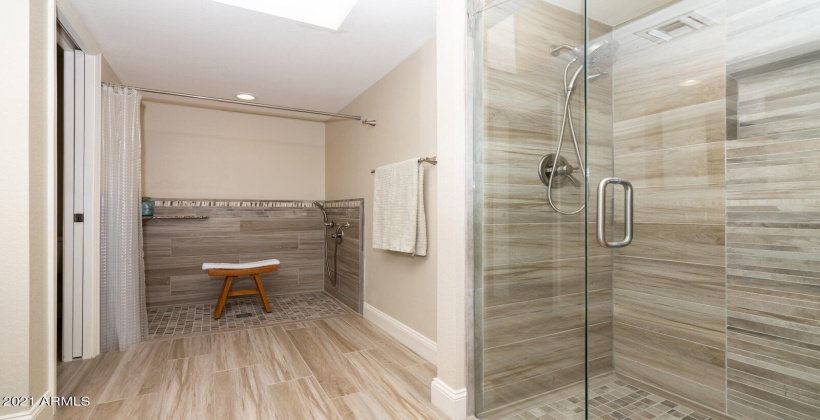 Walk in shower along with a spacious bath area