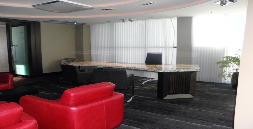 The 'Chairmans' with executive oversized office with Large granite desk, seating area with leather. Floor to ceiling windows to airport and Corp. Jet facility