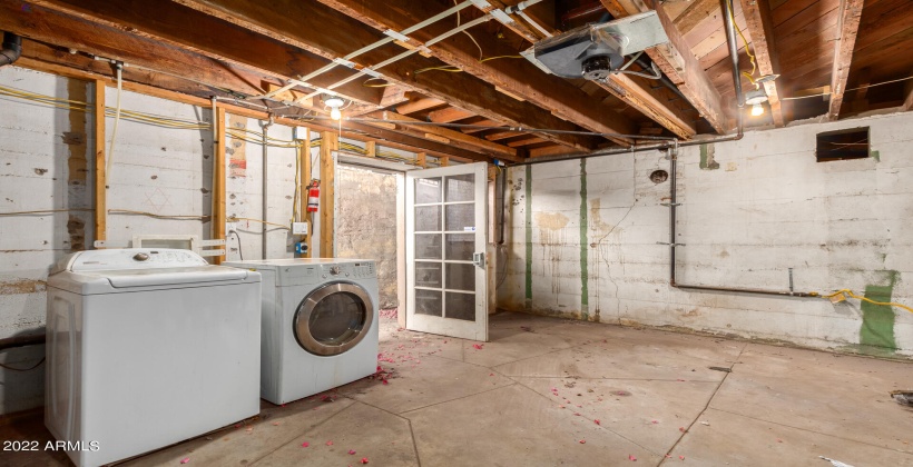 Basement utility room with washer and dryer with exterior access