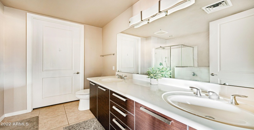 Gorgeous designed cabinets with dual sinks and sophisticated lighting fixtures