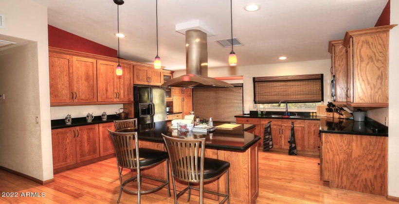 Custom Designed Kitchen with an Island. Wood Floors