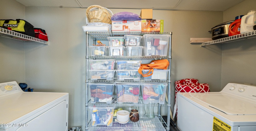 laundry room with full size washer and dryer and storage space