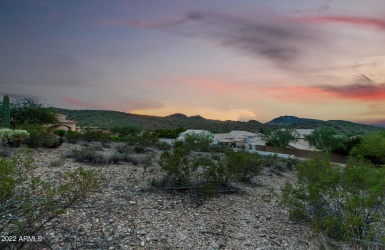 Beautiful mountain and sunset views from this hillside lot.