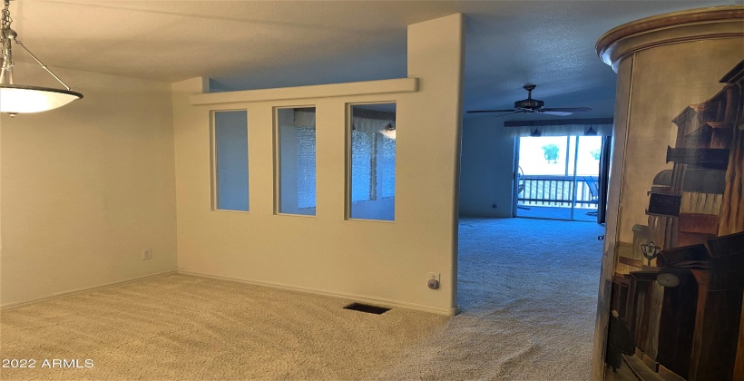 Family room is divided from dining area with decorative wall