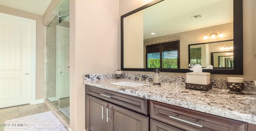 Separate dual sink vanities in primary bathroom