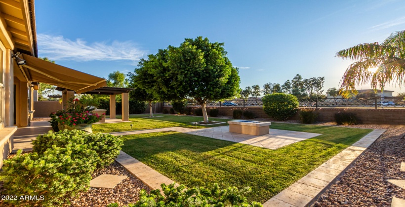 Lush landscaping with outdoor fireplace