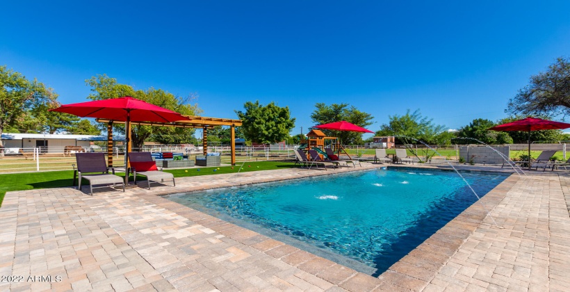 Pristine Resort Style Pool surrounded by Pavers and Multiple Relaxing & Play Areas Excellent for Entertaining