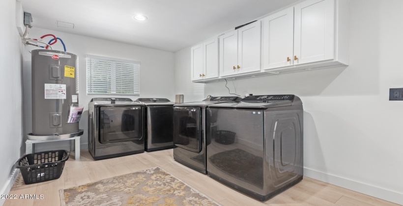 Dual washer/dryers in laundry.